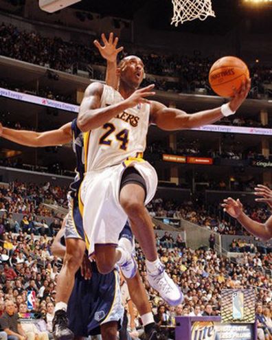  Picture of Kobe Bryant attacking the basket with the Lakers alternate white jersey.